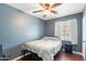 Bedroom with light blue walls, wood flooring, window and ceiling fan at 5137 N 20Th Ave, Phoenix, AZ 85015