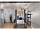 Cozy dining room featuring a modern chandelier, tile flooring, and access to the backyard at 5137 N 20Th Ave, Phoenix, AZ 85015