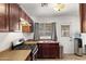 Efficient kitchen with stainless steel appliances, tile flooring and sleek countertops at 5137 N 20Th Ave, Phoenix, AZ 85015