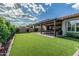 Large backyard with artificial grass, covered patio and room for outdoor activities at 5653 E Sayan St, Mesa, AZ 85215