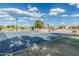 Outdoor basketball court with blue surface, hoops, and benches in a well-maintained community park at 5653 E Sayan St, Mesa, AZ 85215