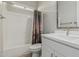 Bright bathroom with a single sink vanity and bathtub with western themed shower curtain at 5653 E Sayan St, Mesa, AZ 85215