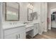 Bright bathroom with double sinks, modern fixtures, and framed mirrors at 5653 E Sayan St, Mesa, AZ 85215