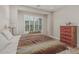 Bright bedroom with shuttered windows and hardwood floors features rustic decor at 5653 E Sayan St, Mesa, AZ 85215