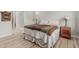 Bright bedroom boasts hardwood floors and an ensuite bathroom with glass enclosed shower at 5653 E Sayan St, Mesa, AZ 85215