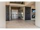 Open-air breezeway with tiled flooring, barn doors, and views of the pool creating a resort-like ambiance at 5653 E Sayan St, Mesa, AZ 85215