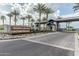 Community entrance with stone monuments, desert landscaping, and palm trees at 5653 E Sayan St, Mesa, AZ 85215
