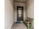 Covered entryway with a decorative metal front door and a rustic wooden bench at 5653 E Sayan St, Mesa, AZ 85215