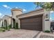 Single Gathering home with a two-car garage, circular turret entry, and patterned brick paved driveway at 5653 E Sayan St, Mesa, AZ 85215