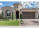 Beautiful single Gathering home featuring a two-car garage, well-manicured lawn, and circular turret entry at 5653 E Sayan St, Mesa, AZ 85215