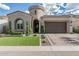 Charming single Gathering home featuring a two-car garage, manicured lawn, and distinctive turret entry at 5653 E Sayan St, Mesa, AZ 85215