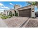 Charming single Gathering home featuring a two-car garage, circular turret entry, and block paved driveway at 5653 E Sayan St, Mesa, AZ 85215