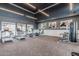 Modern gym with exercise equipment, weights, and ample natural light, designed for an active lifestyle at 5653 E Sayan St, Mesa, AZ 85215