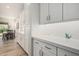 Bright kitchen with white cabinets, tile backsplash, and stainless steel hardware at 5653 E Sayan St, Mesa, AZ 85215