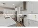 Modern kitchen features a stainless steel range hood, appliances, and a large center island at 5653 E Sayan St, Mesa, AZ 85215