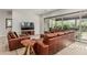 Bright, open living room with modern furniture, a large sectional couch, and a sliding glass door at 5653 E Sayan St, Mesa, AZ 85215