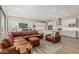 Bright, open living room featuring modern furniture, tv, and seamless flow into the kitchen area at 5653 E Sayan St, Mesa, AZ 85215