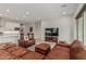 Bright, open living room featuring modern furniture, tv, and seamless flow into the kitchen area at 5653 E Sayan St, Mesa, AZ 85215