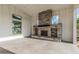 Elegant outdoor fireplace with stone surround in a covered patio, creating a cozy space for relaxation at 5653 E Sayan St, Mesa, AZ 85215