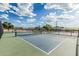 Well-maintained tennis court with net and fencing, perfect for enjoying a game in a community setting at 5653 E Sayan St, Mesa, AZ 85215