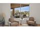 An inside view out to the backyard pool with lounge chairs, a patio, and desert landscaping at 5690 E Canyon Creek Cir, Carefree, AZ 85377