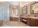 Bathroom featuring glass block details, a soaking tub, and double sinks at 5690 E Canyon Creek Cir, Carefree, AZ 85377