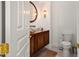 Elegant powder room boasts a glass bowl sink, rich wood vanity, and stylish lighting fixtures at 5690 E Canyon Creek Cir, Carefree, AZ 85377