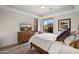 Bedroom featuring a sleek, modern design with desert landscape views and hardwood floors at 5690 E Canyon Creek Cir, Carefree, AZ 85377