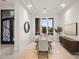 Formal dining room featuring a tray ceiling, stylish furnishings, and large windows at 5690 E Canyon Creek Cir, Carefree, AZ 85377
