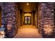 Impressive entryway featuring stone columns, a custom front door, and brick pavers at 5690 E Canyon Creek Cir, Carefree, AZ 85377