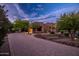 Beautiful Southwestern-style home featuring a brick driveway, desert landscaping, and mountain views at 5690 E Canyon Creek Cir, Carefree, AZ 85377