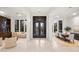 Elegant foyer featuring high ceilings, custom doors, and access to the dining and living areas at 5690 E Canyon Creek Cir, Carefree, AZ 85377