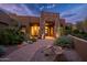 Stunning desert home features a stacked stone entrance, desert plants, and stone pathway at 5690 E Canyon Creek Cir, Carefree, AZ 85377