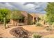 Inviting desert home showcasing stone accents, desert landscaping, and a brick pathway at 5690 E Canyon Creek Cir, Carefree, AZ 85377