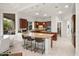 Spacious kitchen with granite island, breakfast bar, and wood cabinetry with stainless appliances at 5690 E Canyon Creek Cir, Carefree, AZ 85377