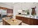 Open-concept kitchen with granite countertops and stainless steel appliances overlooking the living area at 5690 E Canyon Creek Cir, Carefree, AZ 85377