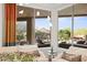 View from living room overlooking the backyard pool, patio, and desert landscaping at 5690 E Canyon Creek Cir, Carefree, AZ 85377