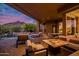 Covered patio features comfortable seating, a fire pit, and scenic mountain views at 5690 E Canyon Creek Cir, Carefree, AZ 85377