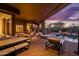 Spacious outdoor patio with multiple seating areas, a pool, fire pit, and sunset views, perfect for entertaining at 5690 E Canyon Creek Cir, Carefree, AZ 85377