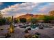Backyard pool area with desert landscaping, rock features, and mountain views at 5690 E Canyon Creek Cir, Carefree, AZ 85377