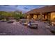 Backyard pool area with desert landscaping, a spa, a fire pit, lounge chairs, and an outdoor kitchen at 5690 E Canyon Creek Cir, Carefree, AZ 85377