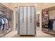 A walk-in closet with a bank of drawers, doors and shelving at 5690 E Canyon Creek Cir, Carefree, AZ 85377