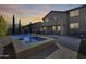 Backyard showcasing a pool and spa, complete with covered patio and desert landscaping for serene outdoor living at 5826 W Plum Rd, Phoenix, AZ 85083