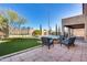 Backyard with a pool, patio, green turf, fire pit, and a trampoline, creating an outdoor living and recreation area at 5826 W Plum Rd, Phoenix, AZ 85083