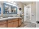 A bathroom with a mirror with a blue frame and a decorated vanity with a white sink at 5826 W Plum Rd, Phoenix, AZ 85083