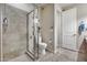 Bright bathroom featuring tiled shower, toilet, tiled floor, and towel rack near the doorway at 5826 W Plum Rd, Phoenix, AZ 85083