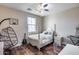 Bedroom with a white bed frame, hanging chair, a guitar, and hard wood floors at 5826 W Plum Rd, Phoenix, AZ 85083