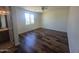 This cozy bedroom boasts wood-look flooring and a ceiling fan for added comfort at 5826 W Plum Rd, Phoenix, AZ 85083