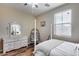 Bedroom features a white bed frame, hanging chair, and hard wood floors at 5826 W Plum Rd, Phoenix, AZ 85083