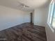 Spacious bedroom with a ceiling fan, wood-look flooring, and plenty of natural light at 5826 W Plum Rd, Phoenix, AZ 85083